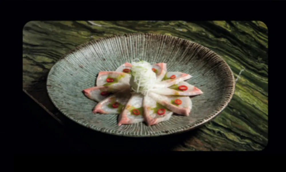 Delicate thin-sliced white fish sashimi with fresh garnish and light sauce at Hungry Bowl Mongolian Grill, Sushi & KBBQ, a Asian Restaurant in Leominster